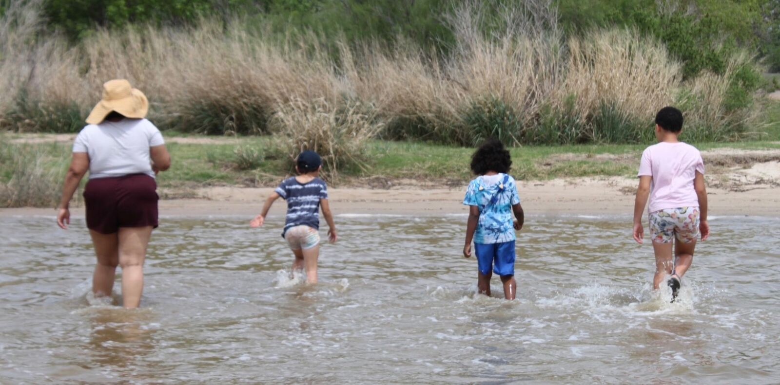 Victoria and her kids playing in the water