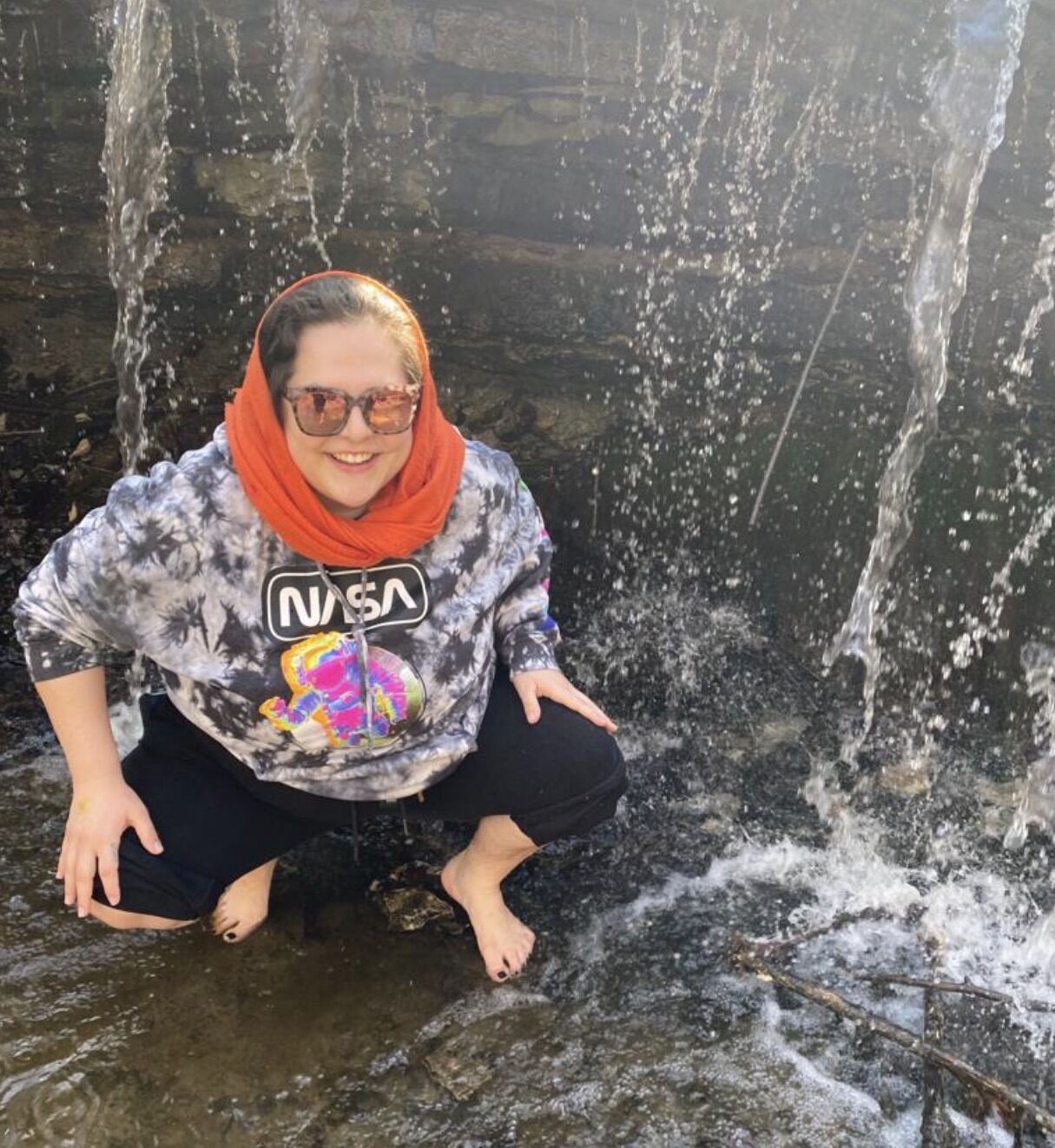 Victoria enjoying a waterfall on a family adventure